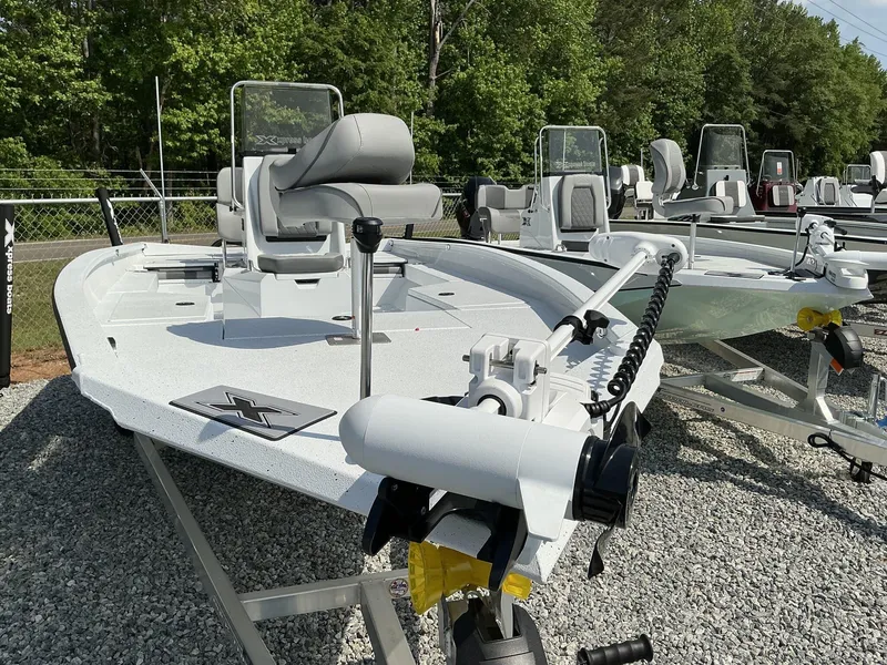 Slide: The Image of 2025 Xpress Hyper-Lift Series H22B boat displayed outdoors on gravel. - 2