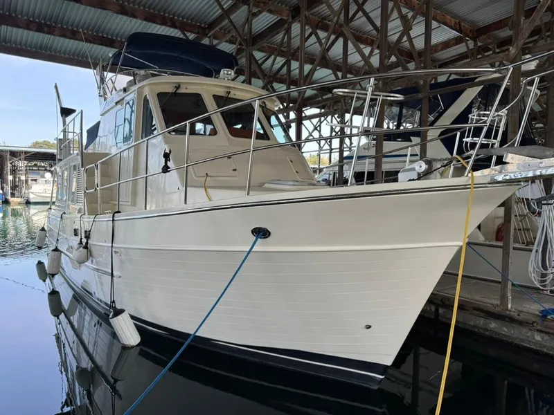 Slide: The Image of 2010 North Pacific 43 Pilothouse yacht docked in a marina. - 0