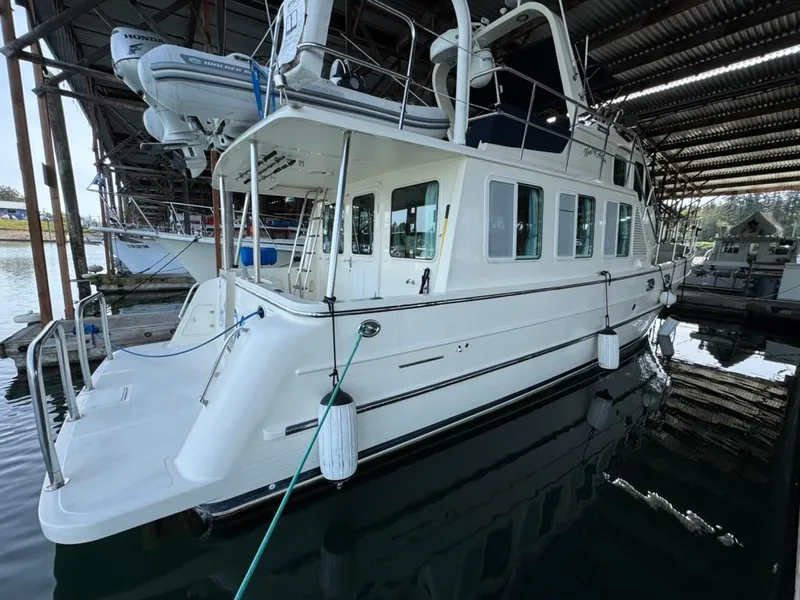 Slide: The Image of 2010 North Pacific 43 Pilothouse yacht docked in a covered marina. - 1