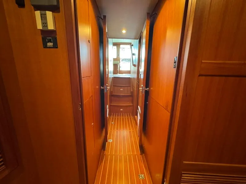Slide: The Image of Interior hallway of 2010 North Pacific 43 Pilothouse with wooden paneling and flooring. - 16