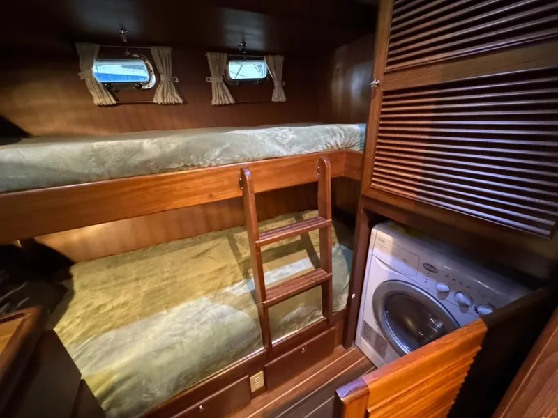 Slide: The Image of Bunk beds and washer in 2010 North Pacific 43 Pilothouse cabin interior. - 19