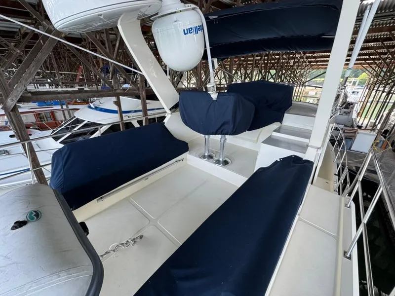 Slide: The Image of 2010 North Pacific 43 Pilothouse yacht with covered seating on deck. - 27