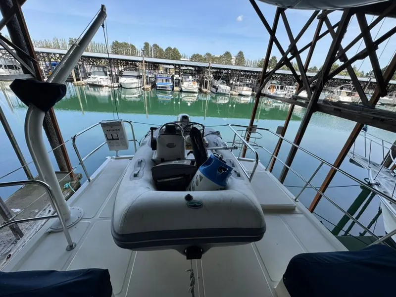 Slide: The Image of 2010 North Pacific 43 Pilothouse yacht docked, featuring a spacious deck and marina view. - 28