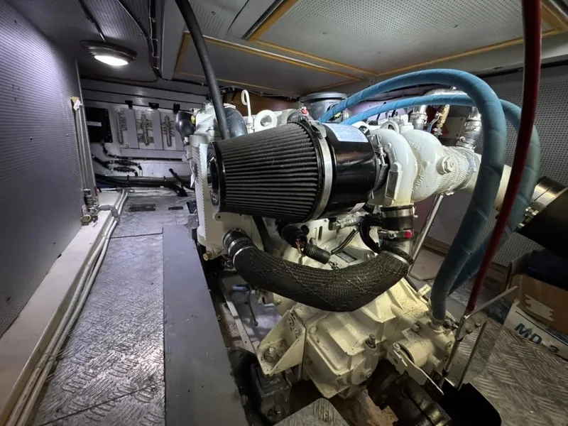 Slide: The Image of Engine room of a 2010 North Pacific 43 Pilothouse with visible components and piping. - 34