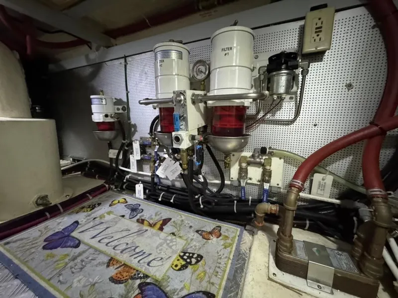 Slide: The Image of Engine room of 2010 North Pacific 43 Pilothouse with fuel filters and decorative welcome mat. - 37