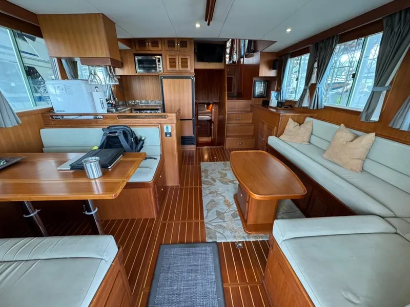 Slide: The Image of Interior of 2010 North Pacific 43 Pilothouse yacht with wood finish and comfortable seating. - 5