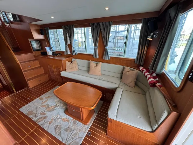 Slide: The Image of Luxurious interior of 2010 North Pacific 43 Pilothouse with cozy seating and wooden accents. - 6