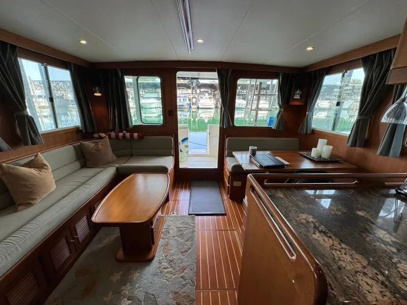 Slide: The Image of Luxurious interior of 2010 North Pacific 43 Pilothouse yacht with elegant seating and dining area. - 9
