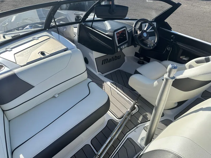 Slide: The Image of 2017 Malibu Response TXi boat interior with sleek seating and modern dashboard. - 12