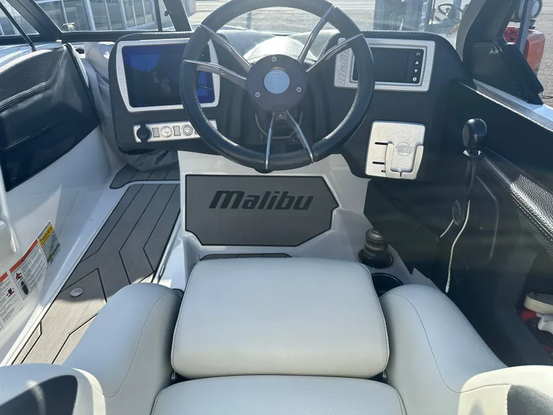 Slide: The Image of Interior of 2017 Malibu Response TXi boat with steering wheel and dashboard controls. - 13