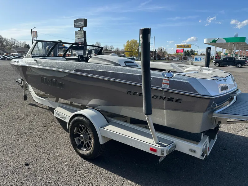 Slide: The Image of 2017 Malibu Response TXi boat on trailer in parking lot, sunny day. - 4