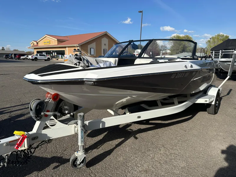 Slide: The Image of 2017 Malibu Response TXi boat on trailer in parking lot, sunny day. - 6