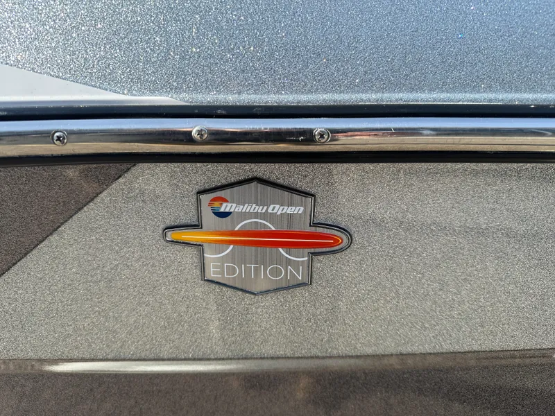 Slide: The Image of 2017 Malibu Response TXi Malibu Open Edition badge on metallic surface. - 8