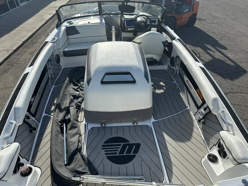 Slide: The Image of 2017 Malibu Response TXi boat interior with sleek seating and modern dashboard. - 9