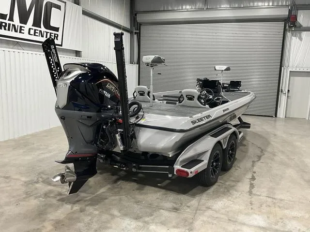 Slide: The Image of 2025 Skeeter FXR21L bass boat in showroom, featuring Yamaha engine and dual console design. - 4
