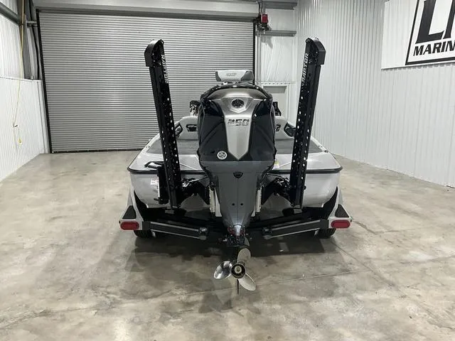 Slide: The Image of 2025 Skeeter FXR21L boat in garage, rear view with motor and propeller visible. - 5