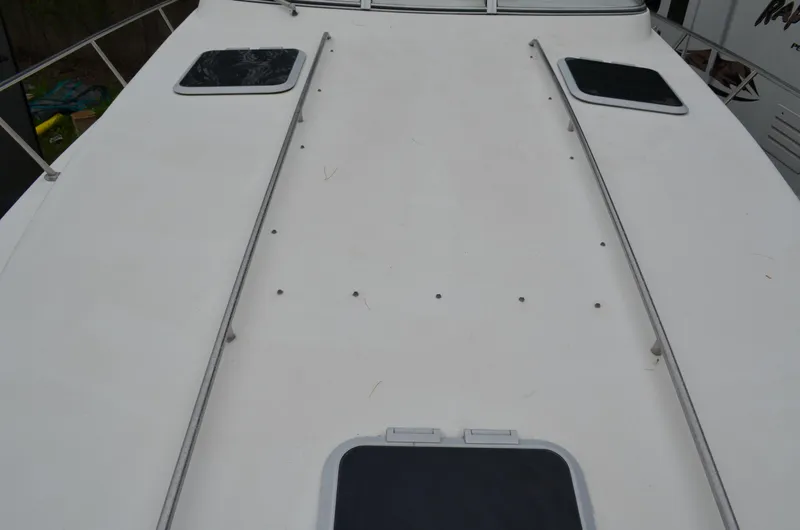 Slide: The Image of 1996 Rinker 300 Fiesta Vee boat deck with hatches and railing. - 14