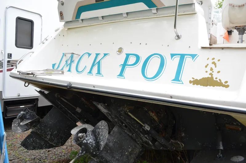 Slide: The Image of 1996 Rinker 300 Fiesta Vee boat named "Jack Pot" with visible propellers. - 15