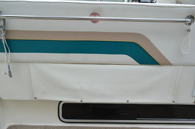 Slide: The Image of 1996 Rinker 300 Fiesta Vee boat detail with teal and beige accents. - 21