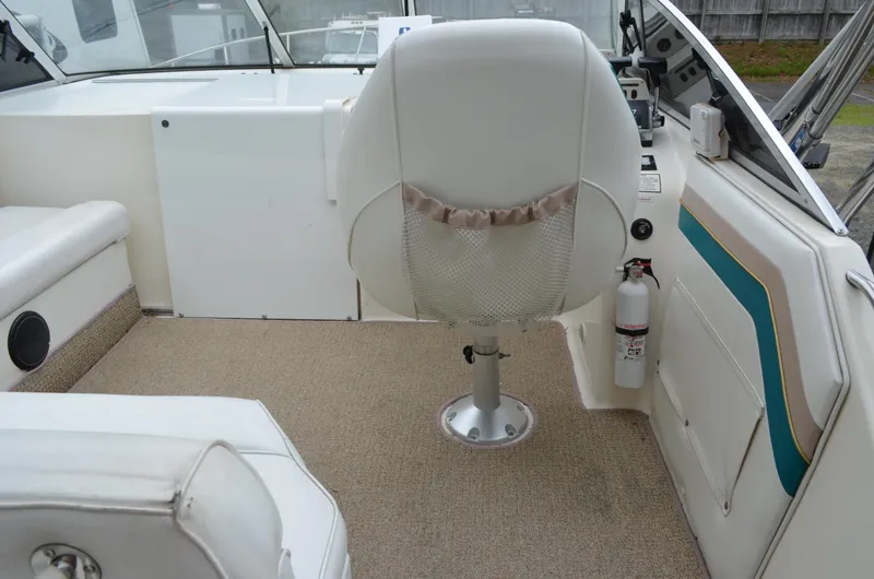 Slide: The Image of Interior of 1996 Rinker 300 Fiesta Vee boat with captain's chair and fire extinguisher. - 22