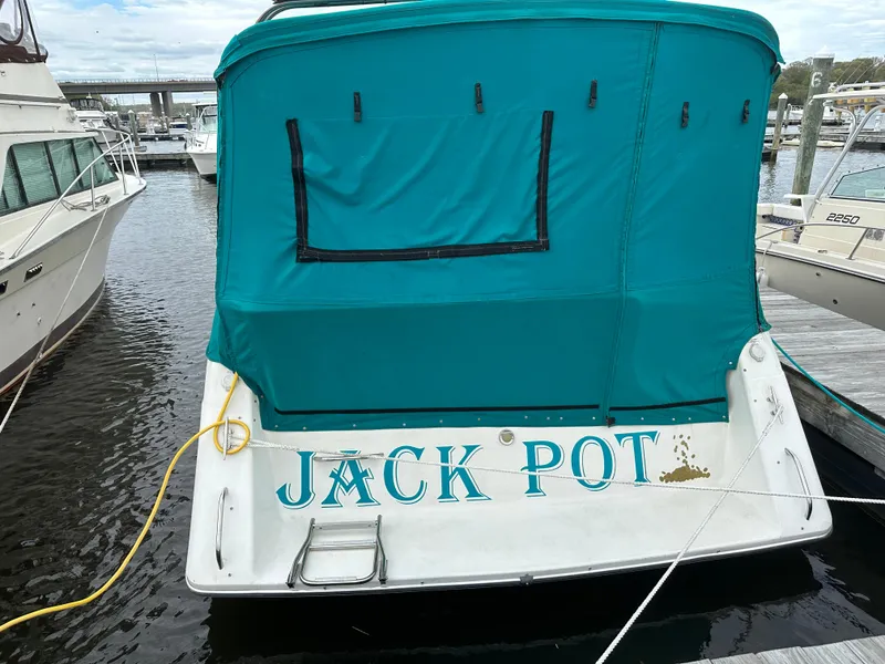 Slide: The Image of 1996 Rinker 300 Fiesta Vee boat named "Jack Pot" docked at marina. - 3