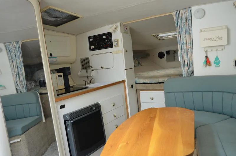 Slide: The Image of Interior of a 1996 Rinker 300 Fiesta Vee boat with kitchenette and seating area. - 35