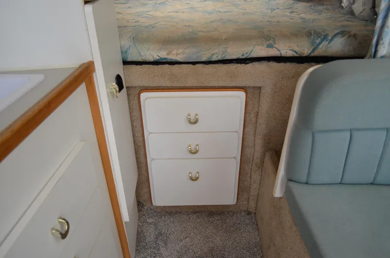 Slide: The Image of Interior of 1996 Rinker 300 Fiesta Vee boat with drawers and seating area. - 37