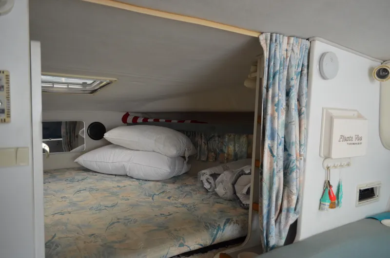 Slide: The Image of Cozy cabin interior of 1996 Rinker 300 Fiesta Vee with bed and pillows. - 38