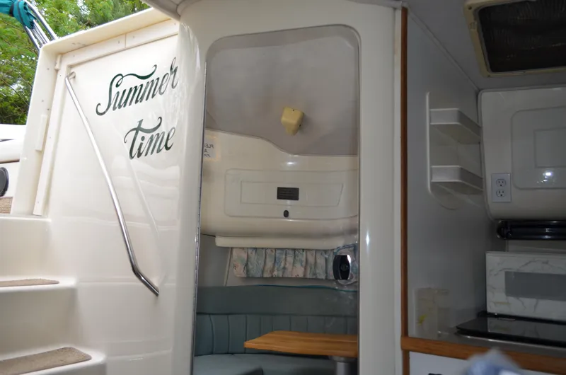 Slide: The Image of 1996 Rinker 300 Fiesta Vee cabin interior with "Summer Time" text on entrance. - 43