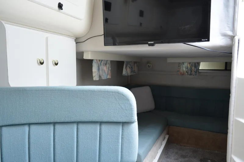 Slide: The Image of Interior of 1996 Rinker 300 Fiesta Vee boat with seating and TV. - 44