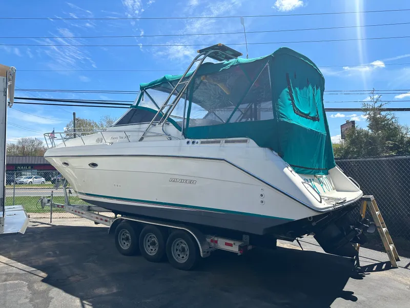 Slide: The Image of 1996 Rinker 300 Fiesta Vee boat on trailer under clear blue sky. - 5