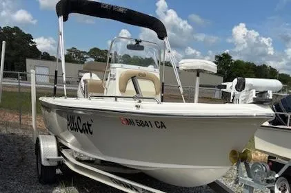 Slide: The Image of 2020 Key West 1720 Sportsman boat on trailer, parked outdoors under cloudy sky. - 1