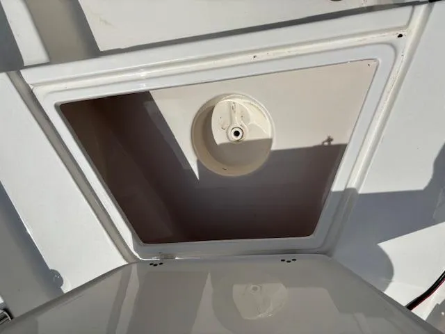 Slide: The Image of 2020 Key West 1720 Sportsman boat compartment with open hatch, showcasing interior details. - 9