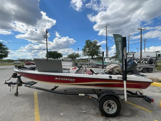 Slide: The Image of 2007 Stratos 176XT boat cruising on clear blue water with two passengers. - 1