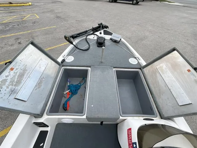 Slide: The Image of 2007 Stratos 176XT boat with open storage compartments and fishing gear. - 11