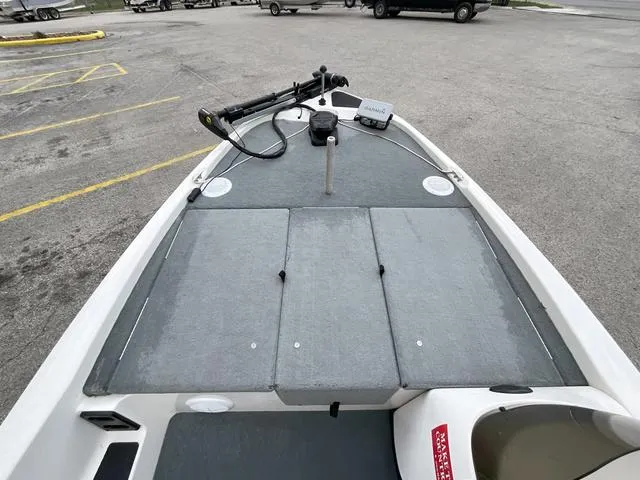 Slide: The Image of 2007 Stratos 176XT boat deck with trolling motor in a parking lot. - 12