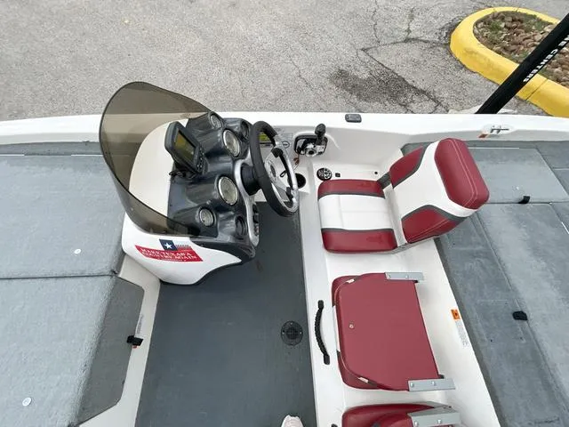 Slide: The Image of 2007 Stratos 176XT boat interior with red and white seats, steering console, and dashboard. - 13