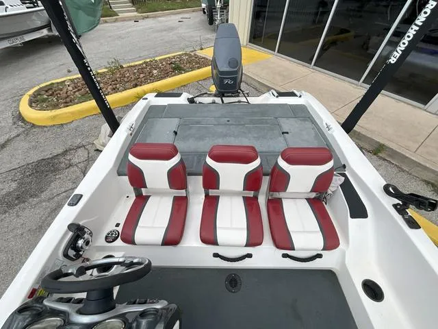 Slide: The Image of 2007 Stratos 176XT boat interior with red and white seating, steering wheel, and motor. - 14