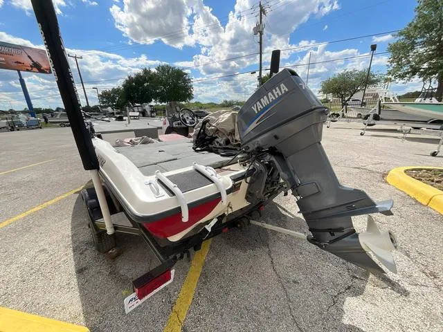 Slide: The Image of 2007 Stratos 176XT boat with Yamaha outboard motor in a parking lot. - 19
