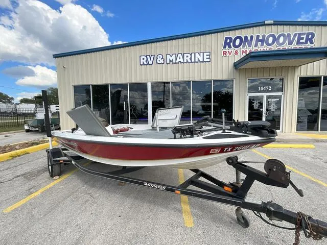 Slide: The Image of 2007 Stratos 176XT boat with blue exterior and seating on a trailer. - 5