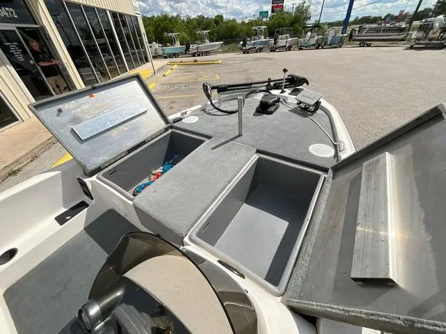 Slide: The Image of 2007 Stratos 176XT boat with open storage compartments and fishing equipment. - 7