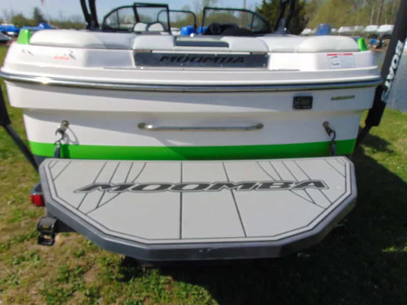 Slide: The Image of 2018 Moomba Mondo boat, rear view with swim platform, parked on grass. - 12