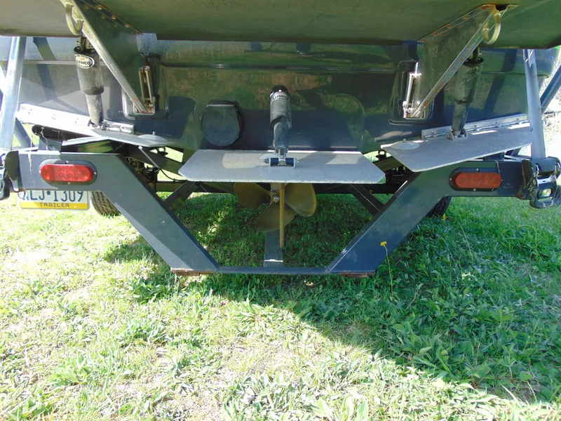 Slide: The Image of Rear view of a 2018 Moomba Mondo boat on grass, showing propeller and trailer. - 13