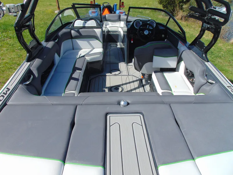 Slide: The Image of 2018 Moomba Mondo boat interior with gray and white seating, open layout, and modern dashboard. - 14