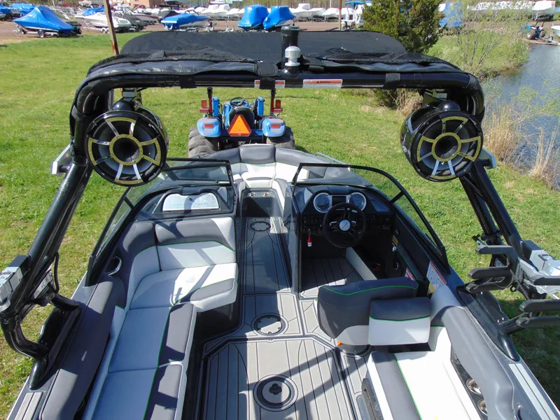 Slide: The Image of 2018 Moomba Mondo boat interior with speakers, sleek seating, and modern dashboard. - 16