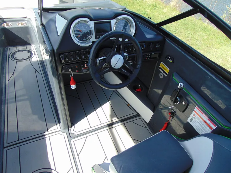 Slide: The Image of 2018 Moomba Mondo boat cockpit with steering wheel and dashboard controls. - 18