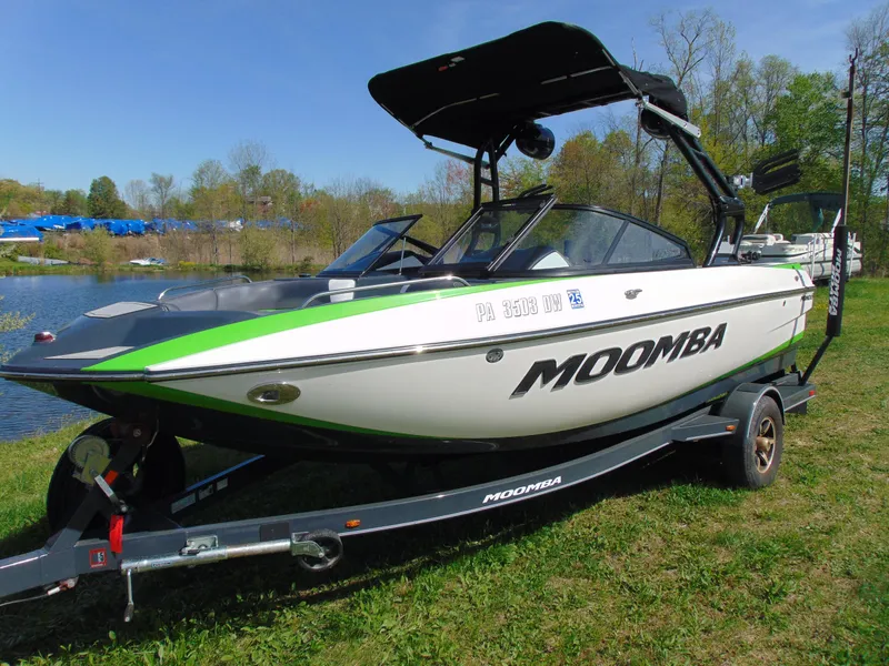 Slide: The Image of 2018 Moomba Mondo boat on trailer by a lake, featuring sleek design and vibrant accents. - 6