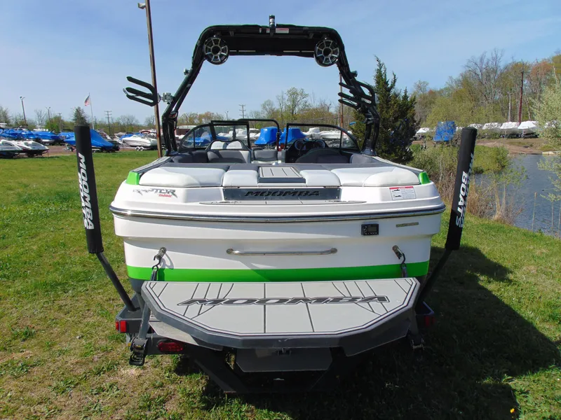 Slide: The Image of 2018 Moomba Mondo boat, rear view, parked on grass near a lake. - 8