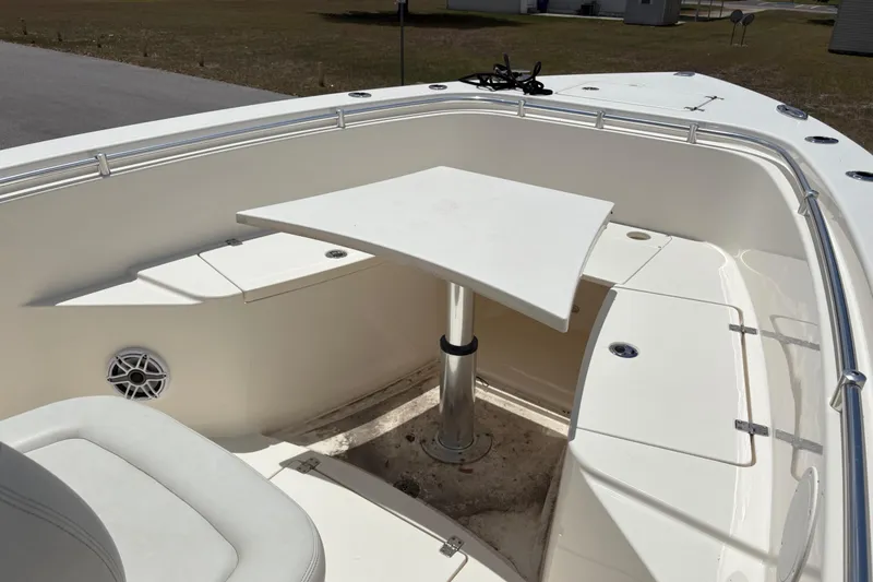 Slide: The Image of 2022 Cobia 301 Center Console boat with seating and table in the bow area. - 18