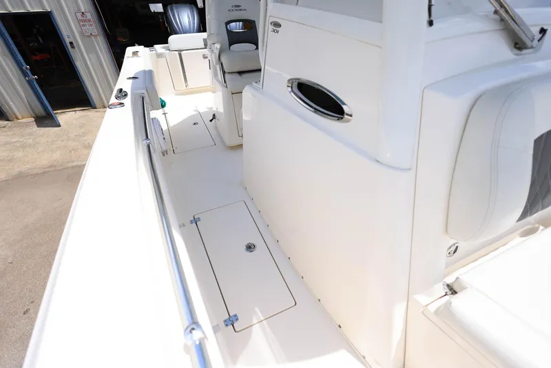 Slide: The Image of 2022 Cobia 301 Center Console boat interior with seating and storage compartments. - 21